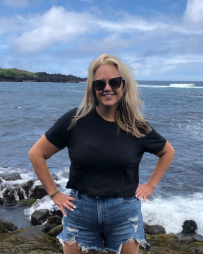 Christine Johnson in front of the rocky shoeline on Kauai