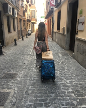 Courtney Miranda pulls a suitcase behind her in Granada, Spain