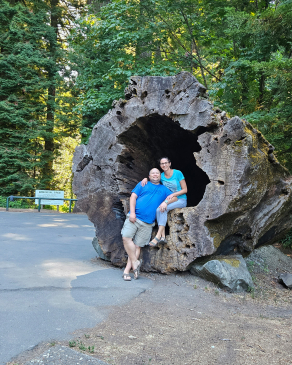Cynthia Kendrick in front of a very large felled tree
