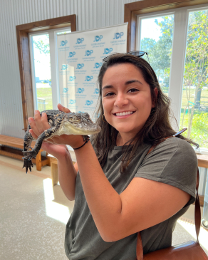 Isa Rubiano holds a juvenile alligator in Louisiana