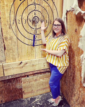Kiki Mannear shows off her axe throwing score