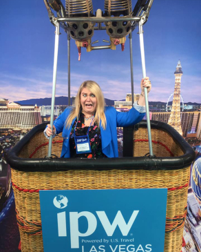Kiki Mannear poses inside a hot air balloon's basket at a photo opp in Las Vegas