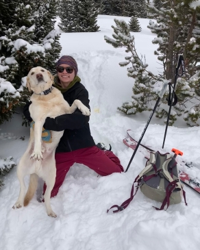 Mattie Hall playing in the snow with her dog in Breckenridge, CO
