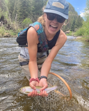 Mattie Hall shows off a rainbow trout she netted in Montana