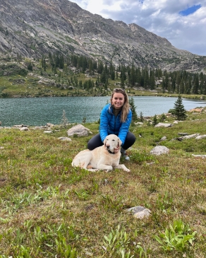 Mattie Hall with her dog at a lakeside in Vail, CO