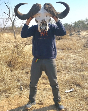 Pat Attkisson holds a bison skull in front of his face like a mask