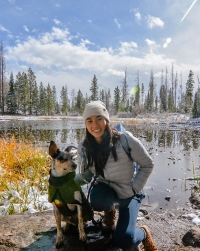 Samantha Sitt alongside a snow-dusted lake with her dog in Colorado