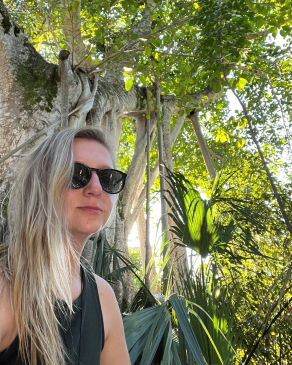 Samantha Sommers next to a banyan tree in Miami, FL