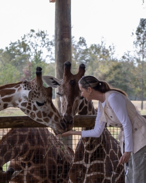 Susi Robichaux interacts with giraffes at Alabama Safari Park
