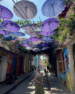 Susi Robichaux on a street topped with purple parasols in Cartagena, Colombia