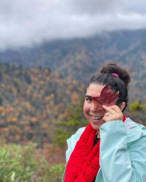 Yasaman Roostaeian holds up a maple leaf in the Great Smoky Mountains