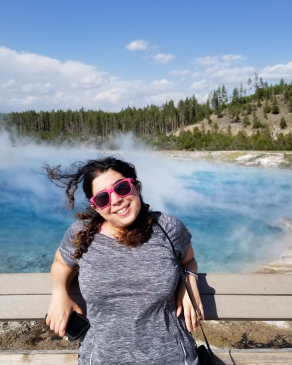 Yasaman Roostaeian in front of a bright blue pool at Yellowstone National Park