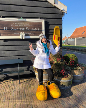 Jackie Contaldo tries on oversized clogs in the Netherlands