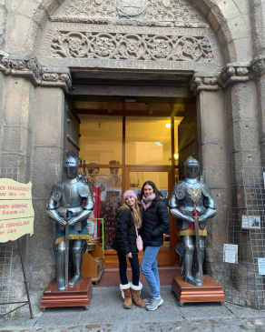 Megan Bookhammer alongside knights' suits of armor in Toledo, Spain
