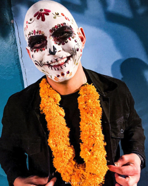 Mike Brock in full makeup and a marigold necklace for Día de los Muertos in Oaxaca, Mexico