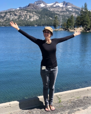 Elodie standing in front of a lake