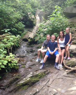 Irish Carroll and his family in a forest