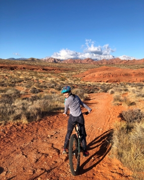 Laura Mier on a bicycle in a desert