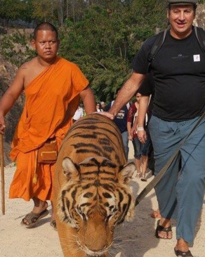 John Deleva walking with a tiger