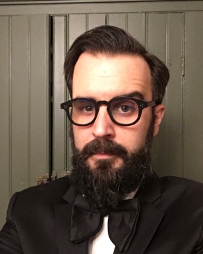 Patrick Rodgers headshot with black glasses