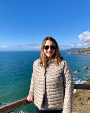Ashley Hughes in front of a beach