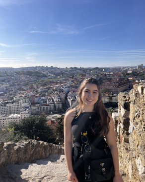 A photo of Lillian with the city of Lisbon as a backdrop
