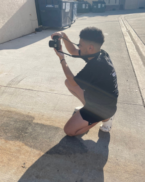 A picture of Andy taking a photo with a DSLR camera