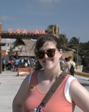 A photo of Katie behind the Costa Maya sign