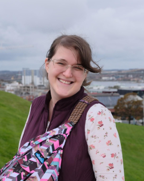A photo of Katie with a city backdrop
