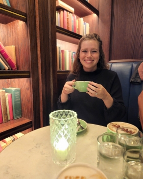 A photo of Holly drinking a cup of coffee