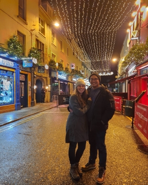 A photo of Holly and her husband in a downtown area.