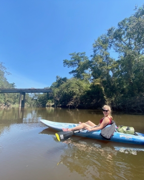 A photo of Anna canoeing on a river in Louisiana. 