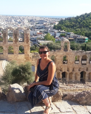 A photo of Nicole in front of ruins in Athens. 