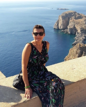A photo of Nicole near the ocean in Greece. 
