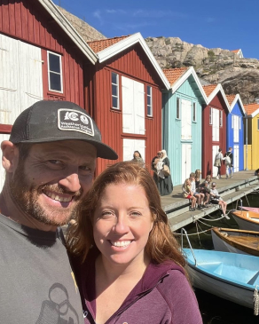 A photo of Rachel next to colorful buildings in Sweden. 
