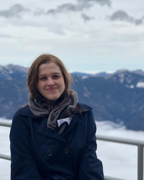 A photo of Angela in front of German mountains. 