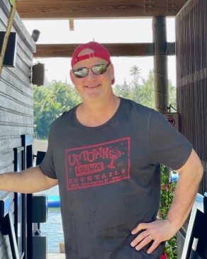 A photo of Richard with his hand on his hip. 