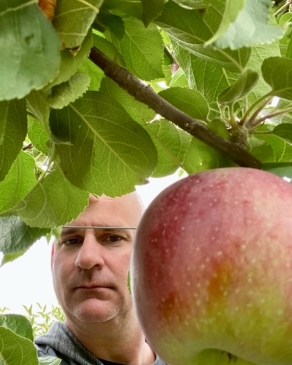 A photo of Richard next to an apple. 