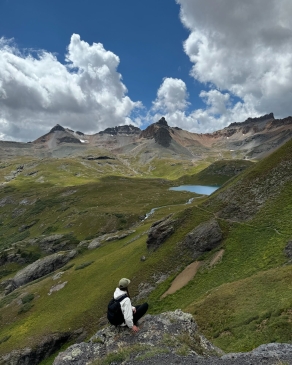 A photo of Shiann in between mountains. 