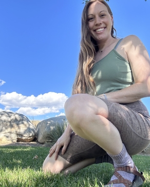 A photo of Andi crouching down. 