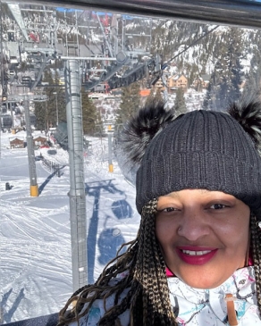 A photo of Jennifer riding ski lift. 