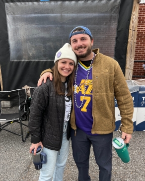 A photo of Victoria and someone with a Jazz jersey at Mardi Gras