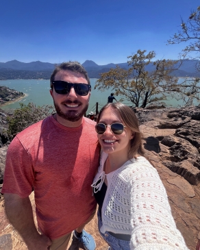 A photo of Victoria and someone above a lake. 