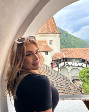 A photo of Larisa overlooking a scenic view. 