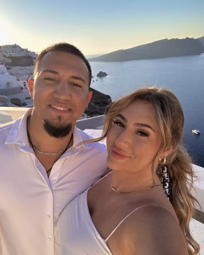 A photo of Larisa and her partner behind an ocean view. 