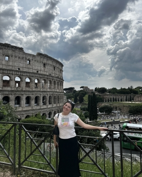 A photo of Maya with the Rome coliseum in the background. 