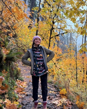 A photo of Kylie in the woods. 