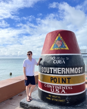 A photo of August posing with the southernmost point in the U.S.