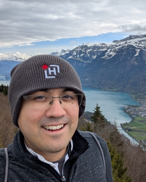 A scenic photo of David near a mountain range. 