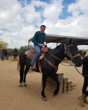 A photo of David on horseback. 